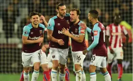  ?? AFP ?? West Ham United’s Andy Carroll ( second from left) celebrates his goal against Stoke City with team mates at the London Stadium on Tuesday. —