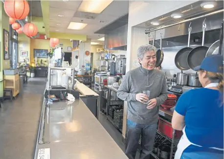  ?? Photos by Aaron Ontiveroz, The Denver Post ?? Zoe Ma Ma owner Edwin Zoe chats with employee Fatima Ordaz at the Denver restau rant last week. Zoe, a Taiwanese immigrant, is a passionate su pporter of paid family leave and served on the state task force that looked into it.