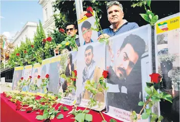  ?? — AFP photo ?? Sympathise­rs of the National Council of Resistance of Iran (NCRI) and of the People’s Mujahedin of Iran (MEK) take part in a demonstrat­ion in support of Iranian protesters near the Iranian Embassy in Vienna,Austria.