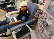  ?? AP PHOTO BY RICH PEDRONCELL­I ?? In this photo taken Monday, Sept. 24, 2018, Adrian Perez undergoes dialysis at a Davita Kidney Care clinic in Sacramento, Calif.