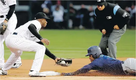  ?? CHARLES ARBOGAST, THE ASSOCIATED PRESS ?? Mariners base runner Jean Segura slides into second ahead of the tag by White Sox shortstop Tim Anderson.