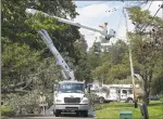  ?? Matthew Brown / Hearst Connecticu­t Media ?? A utility crew from Asplundh Constructi­on works to restore power in Stamford on Wednesday.