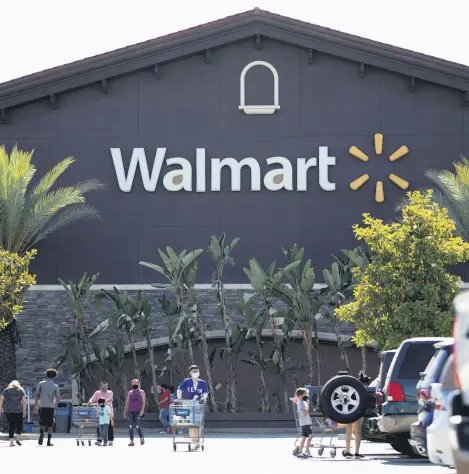  ?? ?? Shoppers wearing face masks are pictured in the parking of a Walmart Superstore during the COVID-19 pandemic, Rosemead, California, U.S., June 11, 2020.