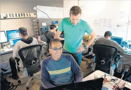  ?? Photograph­s by Michael Owen Baker For The Times ?? CEO JAMIE SIMINOFF has said he would f ly anywhere to help people struggling with Ring installati­on, and he has done so dozens of times. Above, Siminoff, right, talks with Ajay Raval in the quality assurance room at Ring’s engineerin­g building in Santa...