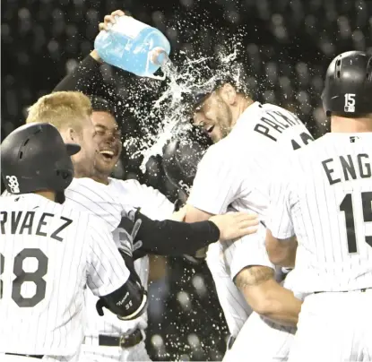  ?? GETTY IMAGES ?? Daniel Palka is mobbed by teammates after hitting a two-run, game-winning single in the ninth inning Tuesday.