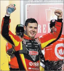  ?? Carlos Osorio ?? The Associated Press Kyle Larson celebrates after winning at Michigan Internatio­nal Speedway on Sunday, the second straight year he was victorious on the 2-mile track in Brooklyn, Mich.