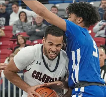  ?? Peter Diana/Post-Gazette ?? Central Connecticu­t State’s Xavier Wilson, right, fouls Robert Morris’ Yannis Mendy.