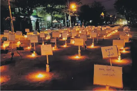  ?? AFP ?? A vigil in Myanmar’s commercial capital Yangon after a girl, 7, was killed in her home by security forces