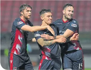  ??  ?? Ross County’s Josh Mullin celebrates after scoring opening goal