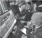  ?? DREW / ASSOCIATED PRESS ?? Trader Timothy Nick, right, works on the floor of the New York Stock Exchange on Aug. 5, 2019.