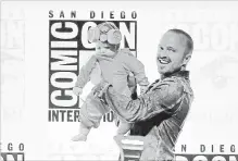  ?? KEVIN WINTER GETTY IMAGES ?? Aaron Paul with his daughter, Story, walks onstage at the “Breaking Bad” 10th Anniversar­y Celebratio­n during Comic-Con Internatio­nal 2018 at San Diego Convention Center this week.