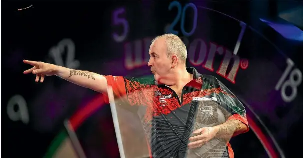  ??  ?? Phil ‘The Power’ Taylor in action during his fairytale run to the final of the world championsh­ips, the last event of his illustriou­s career.