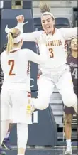  ??  ?? Cassie Foster (3) and Emma Pospisil (2) celebrate after a buzzer-beating win against Beaver.