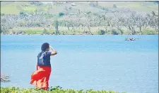  ?? Picture: JOVESA NAISUA ?? FEBRUARY 19 Opposition MP Lenora Qereqereta­bua overlooks the patches of bare trees from the opposite end of the Sigatoka River.