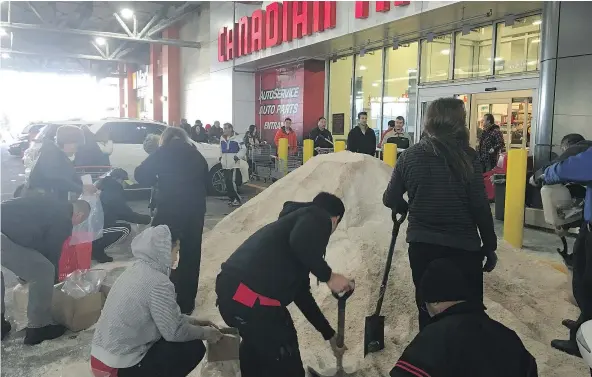  ??  ?? A lineup the length of the building developed outside Canadian Tire on Grandview as people scrambled to load up on road salt Thursday.