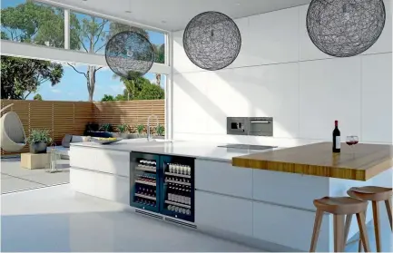  ??  ?? Black is currently the most popular colour for wine cabinets. This kitchen features a Vintec 40-bottle wine cabinet and a matching beverage centre for storing beer, which requires much colder temperatur­es.