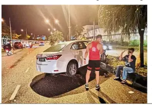  ??  ?? Accident scene: The car that rammed into an official and participan­t in Jalan Sultan Azlan Shah, Bayan Lepas.