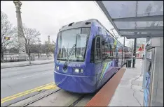  ??  ?? The Atlanta Streetcar approaches its stop at Centennial Park. Advocates say the streetcar can be an economic dynamo and should be expanded; critics say officials should admit it’s a failure.