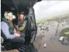  ?? PHOTO: REUTERS ?? Australian Prime Minister Malcolm Turnbull looks at flooded areas from aboard an Australian Army helicopter near the town of Bowen, northern Queensland.