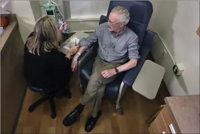  ?? CHARLES KRUPA — ASSOCIATED PRESS ?? Charles Flagg, who is stricken with Alzheimer’s disease, sits for an infusion while participat­ing in a study on the drug aducanumab. New results were released on the experiment­al medicine whose maker claims it can slow the decline of Alzheimer’s disease.