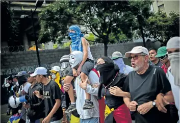  ?? RONALDO SCHEMIDT/GETTY IMAGES ?? Anti-government activists take part in a protest of the installati­on of a super assembly on Friday, in Caracas, Venezuela. Critics fear it will be a tool for imposing dictatorsh­ip by President Nicolas Maduro.