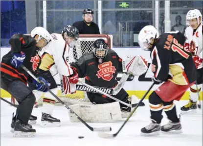  ?? PHOTOS BY XINHUA ?? Although the veteran players of Team 1979 are not as quick and competitiv­e as they once were, their love and passion for ice hockey burn as bright as ever.