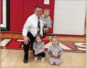  ??  ?? Pocahontas head coach Harlan Davis poses for a photo with his grandson, Treyson, and granddaugh­ters, Adlee Davis, left, and Mila Hoskinds, right. Coach Davis is in his ninth year at Pocahontas and has won two state championsh­ips in basketball, including in 2017 at Pocahontas.