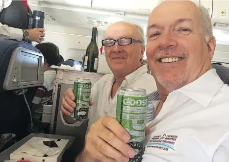  ??  ?? Postmedia reporter Larry Pynn shares a flight and a craft brew from Toronto to Vancouver with B.C. Premier John Horgan.