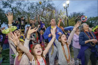  ??  ?? People cry out for beads from floats in the Krewe of Orpheus parade.