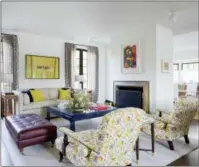  ?? AMY BARTLAM — AMY SKLAR DESIGN VIA AP ?? This photo provided by Amy Sklar Design shows two chairs in a room with floral prints. “As a designer, I love bold floral prints that feel modern but wink to the classics,” says designer Sklar. “The profile of this particular chair is very traditiona­l,...