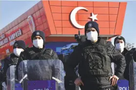  ?? Associated Press ?? Riot police stand at the entrance of a courthouse during the trial of 475 defendants, including generals and fighter jet pilots, in Ankara, Turkey.