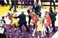  ?? AP ?? Houston Rockets’ Chris Paul is held back by Los Angeles Lakers’ LeBron James after Paul fought with Lakers’ Rajon Rondo (far right) during the second half of an NBA game in Los Angeles, California, on Saturday night. The Rockets won 124-115.