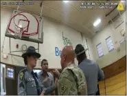  ?? OHIO STATE HIGHWAY PATROL VIA AP ?? This shows police bodycam footage of NewsNation correspond­ent Evan Lambert interactio­n with the leader of the Ohio National Guard Feb. 8 in the gymnasium of an elementary school in East Palestine, Ohio.