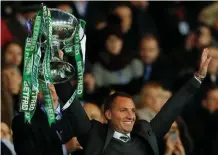  ?? PA WIRE ?? Brendan Rodgers celebrates with the trophy after Celtic’s victory over Motherwell in the Scottish League Cup final Cup final at Hampden Park