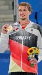  ?? — AP ?? Alexander Zverev of Germany poses with his gold medal after winning the men’s singles final of the tennis competitio­n in Tokyo on Sunday.
a