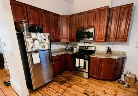  ?? Photos by Jim Franco / Special to the Times Union ?? The kitchen of Danielle Manupella’s brownstone apartment in Saratoga Springs. Despite a fire a few years ago in her unit, the owner restored them.