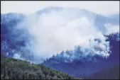  ?? Hugh Carey The Associated Press ?? A fire grows Friday in the Williams Fork Range near Silverthor­ne, Colo.