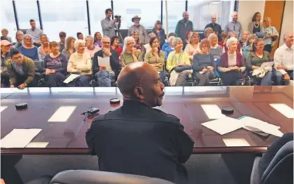  ?? Helen H. Richardson, The Denver Post ?? Denver Police Chief Robert White takes questions from members of People Power at department headquarte­rs on Tuesday. White talked about the department’s policy on immigratio­n.