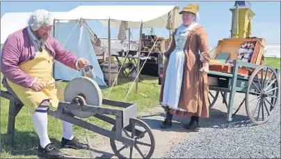  ?? LAURA JEAN GRANT/CAPE BRETON POST ?? Re-enactors Jayar and Jenny Milligan, portraying a knife grinder and petty merchant, were part of Culture Fête at the Fortress of Louisbourg.