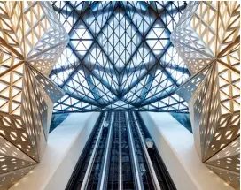  ??  ?? FORM AND FUNCTION Clockwise from below: The cavernous Morpheus atrium; the entrance to Alain Ducasse at Morpheus; and Morpheus Boutique. Opposite page: Zaha Hadid's futuristic exterior of the resort