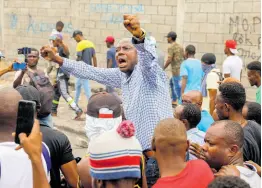  ?? AP PHOTOS ?? Former presidenti­al candidate Moϊse Jean-Charles (centre) chants antigovern­ment slogans during a protest against Haitian Prime Minister Ariel Henry in Port-au-Prince, Haiti, Monday, February 5.