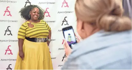  ?? JOSMAR TAVERAS/USA TODAY ?? Ashley Stewart, a clothing retailer that caters to African-American women sizes 12 and up, has a unique connection with customers like Rhondesia Jones, above, who recently showed off a new outfit at the Harlem store in New York City.