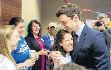  ?? Erik S. Lesser European Pressphoto Agency ?? D E M O C R AT Jon Ossoff greets campaign volunteers in Atlanta on Tuesday morning. He later told supporters: “We are changing the world and your voices are going to ring out across this state and across this country.”