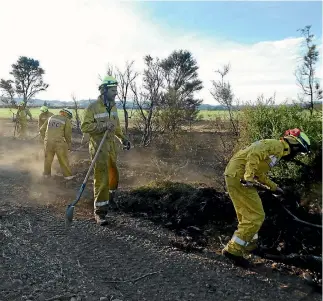  ?? PHOTO: SUPPLIED/DEPARTMENT OF CONSERVATI­ON ?? North Canterbury and High Country fire teams from the Department of Conservati­on work on hot spots in the Medbury Scientific Reserve.