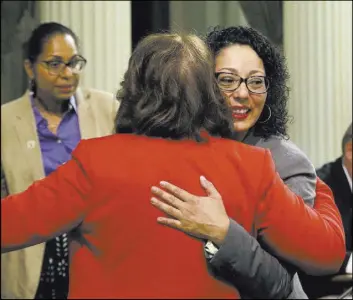  ?? Rich Pedroncell­i The Associated Press ?? Democratic Assemblywo­man Cristina Garcia, right, is hugged by a colleague on her first day back in the Assembly since she was cleared of sexual misconduct allegation­s.