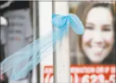  ?? Charlie Neibergall / Associated Press ?? A ribbon for then-missing University of Iowa student Mollie Tibbetts hangs on a light post.