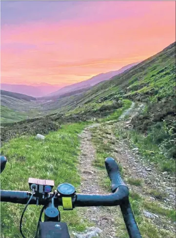  ?? ?? Sunrise on the Badger Divide as Donnie Campbell, inset, makes his 200-mile off-road cycle from Glasgow to Inverness