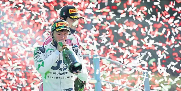  ??  ?? UNLIKELY WINNER: Unfancied French driver Pierre Gasly gets bubbly on the podium after his victory for Alfa Tauri in the Italian Grand Prix yesterday