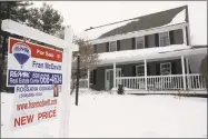  ?? Steven Senne / Associated Press ?? A real estate for sale sign hangs in front of an existing home, in Walpole, Mass.