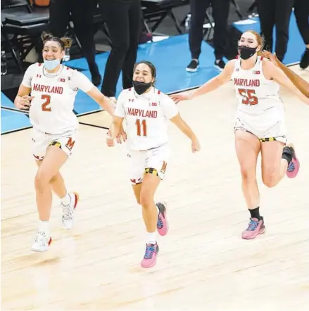  ?? DARRON CUMMINGS/AP PHOTOS ?? Maryland’s Mimi Collins (2), Katie Benzan (11) and Chloe Bibby (55) celebrate after the Terps’ 104-84 victory over Iowa on Saturday in the Big Ten tournament championsh­ip game.